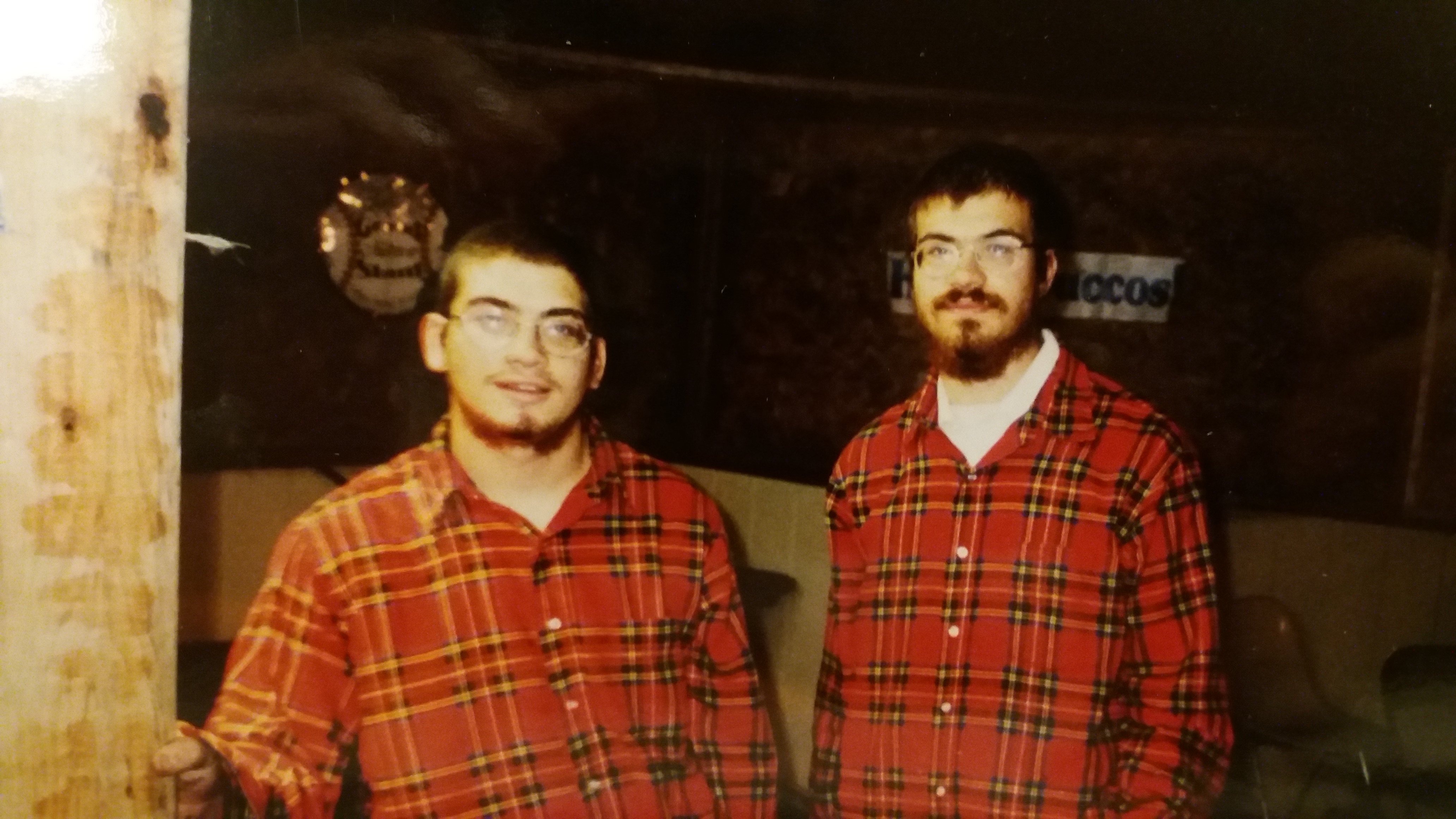 This is a Photo of Rabbi Mendel's brothers Yossi and Shmuly taking down a Sukkah in Flannel Shirts